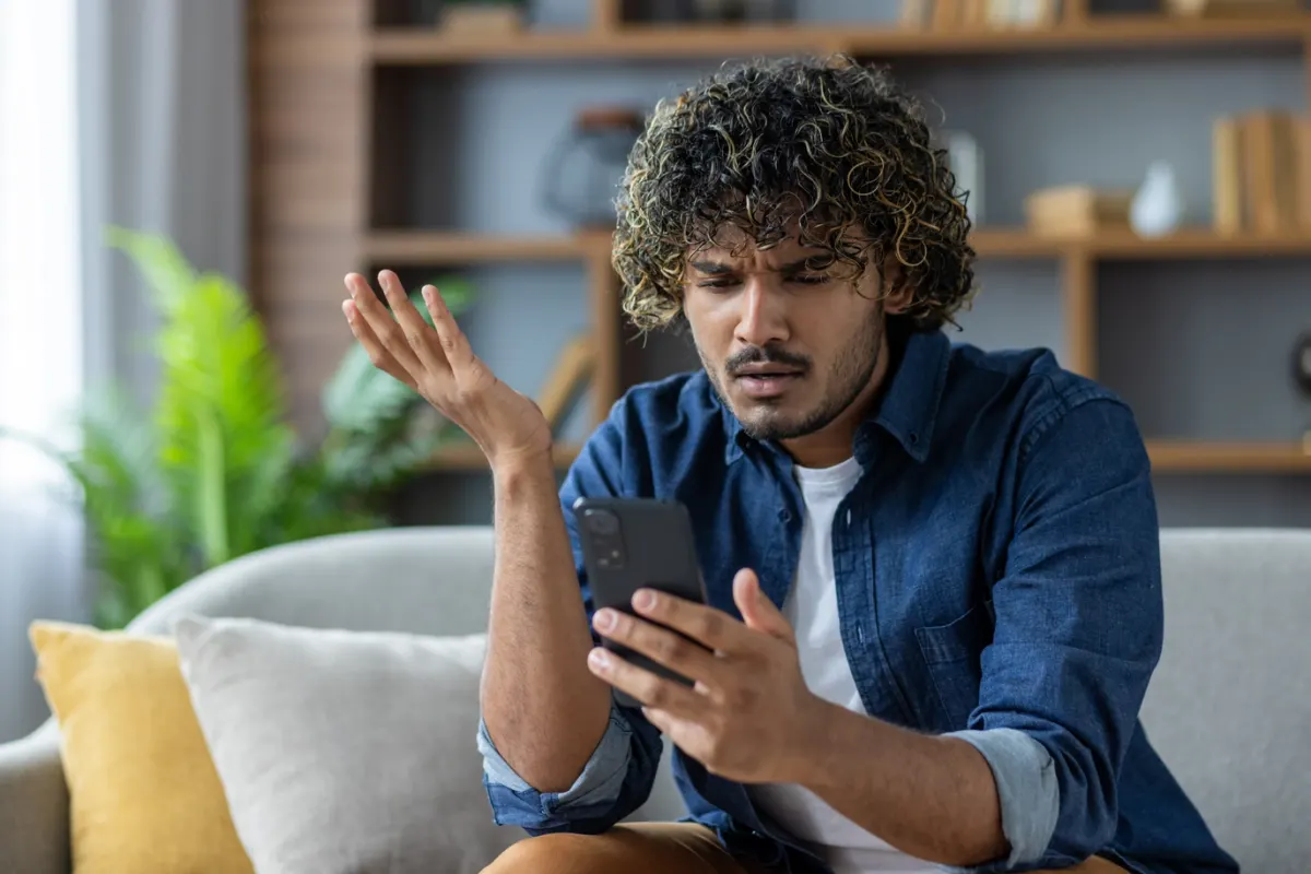 Guest looking confused while searching for answers on their phone